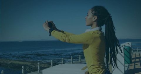 Woman Taking Photo Along Beach Using Phone