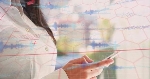 Asian woman wearing white coat holding smartphone with hex grid and waveform overlays