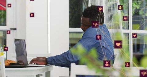 Man Networking on Laptop with Icons and Features in Outdoor Setting