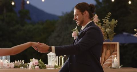 Joyful Couple Dancing at Garden Wedding Reception Under Twinkling Lights