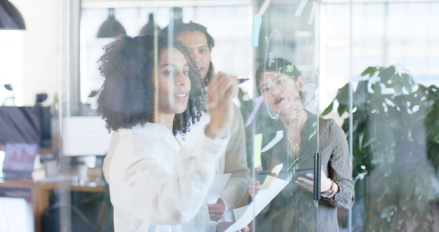 Diverse Team Brainstorming and Collaborating on Glass Board in Modern Office - Download Free Stock Images Pikwizard.com