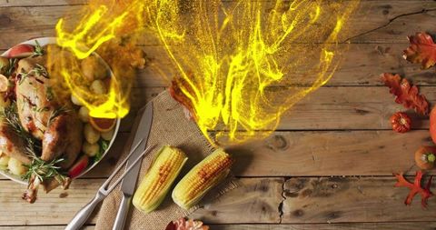 Rustic harvest feast featuring roasted chicken, grilled corn and golden flame overlay