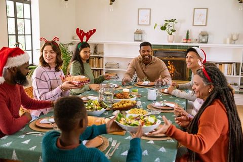 Diverse Family Sharing Christmas Meal in Cozy Home