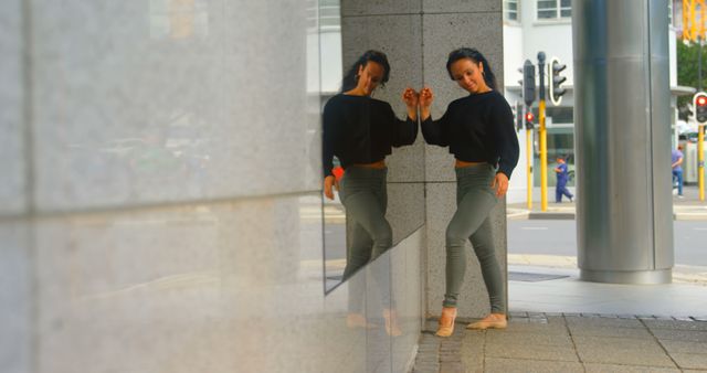 Woman Leaning Against Urban Building Reflective Surface - Download Free Stock Images Pikwizard.com