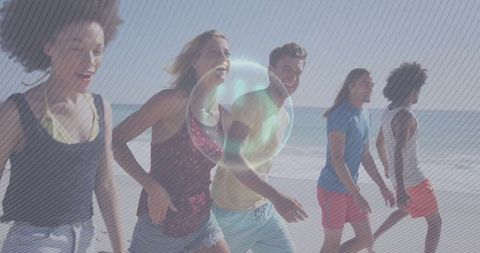 Energetic group of friends running on beach