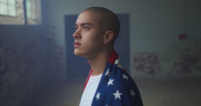 Young Man in Industrial Space Wrapped in American Flag - Download Free Stock Images Pikwizard.com