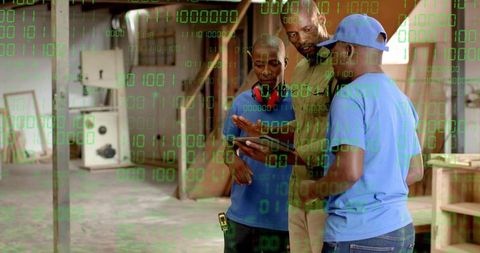 Workshop Team Studying Tablet for Carpentry Training and Manufacturing Innovation