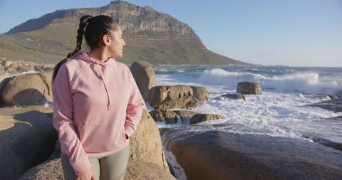 Woman in Activewear Enjoying Coastal Ocean View for Outdoor Adventure
