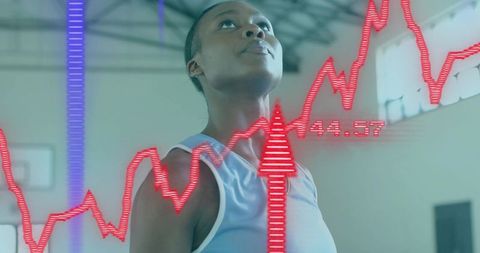 Woman athlete focusing on goal with digital performance hud overlay in indoor court
