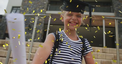 Joyful Schoolgirl Celebrating Graduation with Diploma and Confetti - Download Free Stock Images Pikwizard.com