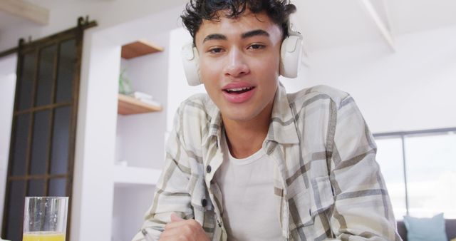 Young Man Listening to Music with Headphones at Home - Download Free Stock Images Pikwizard.com