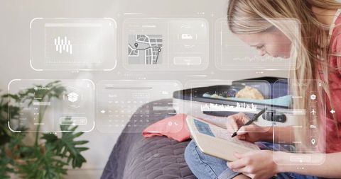 Young woman planning trip using notebook with futuristic hud overlays while packing suitcase