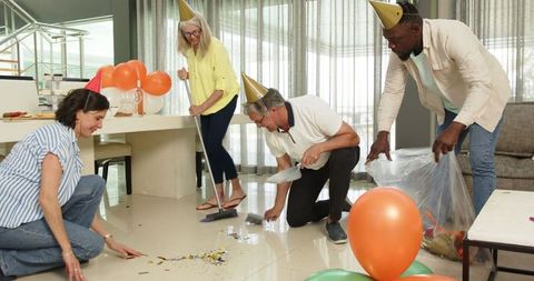 Colleagues Cleaning After Office Party Celebration