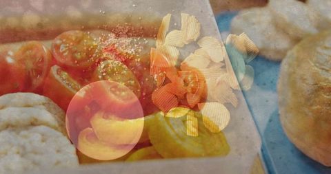 Gourmet tomato and chip platter with rice crackers and rolls