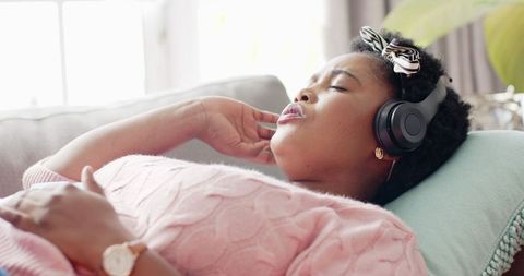 Relaxed African American Woman Listening to Music at Home