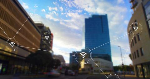 Urban wi-fi network overlay connecting glass skyscraper and downtown streets