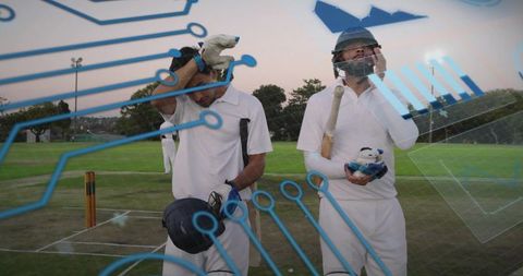 Cricket players walking off field carrying gear at dusk with futuristic digital analytics