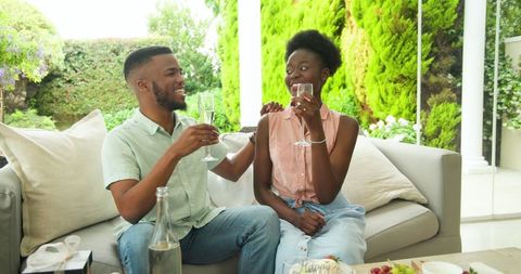 Couple Relaxing on Patio Enjoying Drinks and Conversation