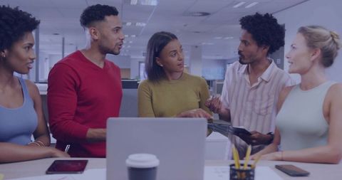 Diverse Team Collaborating in Open-Plan Office Environment