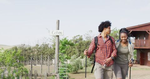 Happy African American Couple Hiking Near Countryside Cabin