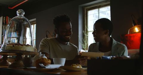 Happy African American Couple Enjoying Coffee in Cozy Cafe