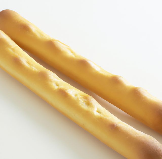 Close up of breadsticks on white background created using generative ai technology. Food and nutrition concept, digitally generated image.