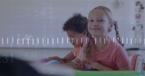 Smiling schoolgirl holding pencil and notebook in classroom with abstract data overlay