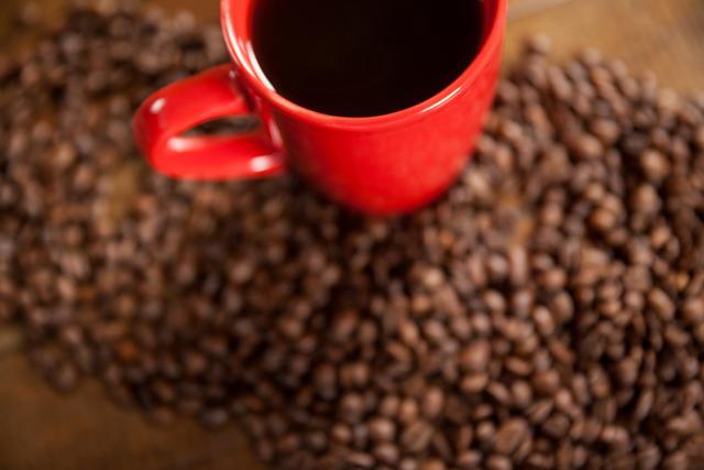 Red Coffee Cup and Coffee Beans on Wooden Table - Download Free Stock Photos Pikwizard.com