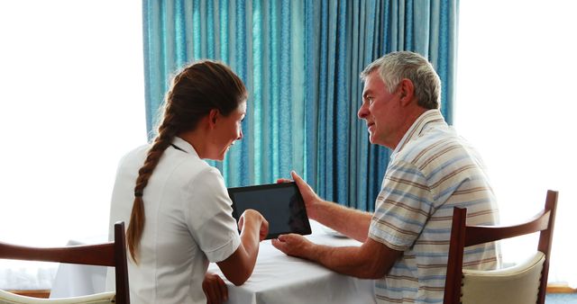 Nurse Interacting with Elderly Patient Using Tablet - Download Free Stock Images Pikwizard.com