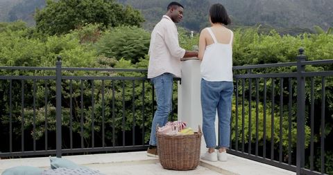 Couple arranging outdoor patio for leisure and relaxation