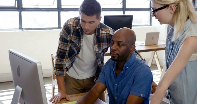 Diverse Team Collaborating on Computer Project in Office - Download Free Stock Images Pikwizard.com