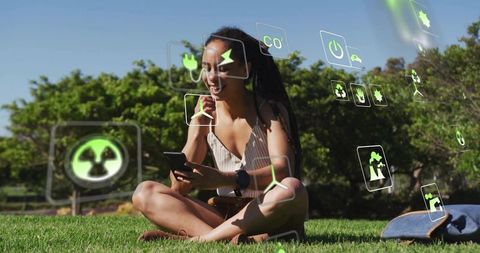 Joyful Woman Using Smartphone Outdoors with Eco Icons Overlaid