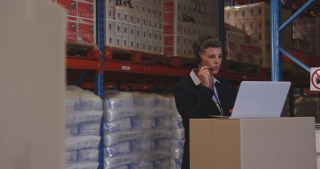 Warehouse Manager Communicating Over Headset While Using Laptop - Download Free Stock Images Pikwizard.com