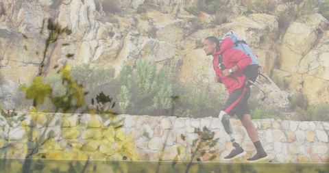 Man with Prosthetic Leg Hiking Through Rocky Landscape