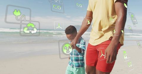 Father and son walking on beach holding hands with eco energy icons for sustainable future