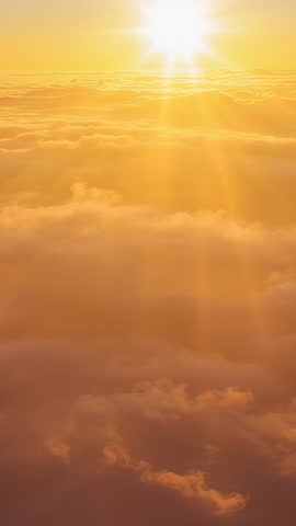 Sun Rising Above Sea of Clouds | Vertical Sunrise Video with Golden Rays and Soft Clouds