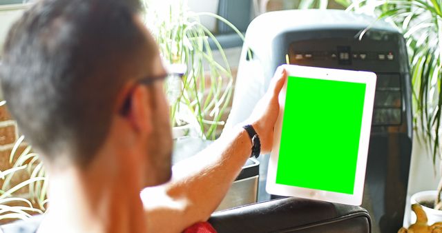 Man Holding Tablet with Green Screen in Modern Home Interior - Download Free Stock Images Pikwizard.com