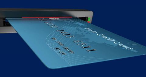 Blue world credit card inserting into payment terminal showing embossed numbers and led