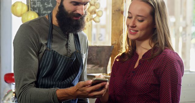 Friendly Barista Assisting Customer with Mobile Order at Cafe - Download Free Stock Images Pikwizard.com