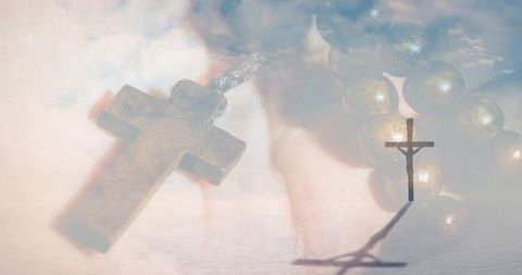 Wooden cross pendant and rosary beads with crucifix shadow in cloud water double exposure