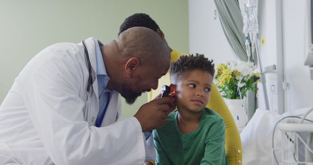 African american male doctor examining child patient at hospital - Download Free Stock Photos Pikwizard.com