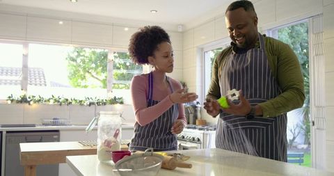 Couple Baking Together in Sunlit Modern Kitchen Mixing Dough and Rolling Cookies