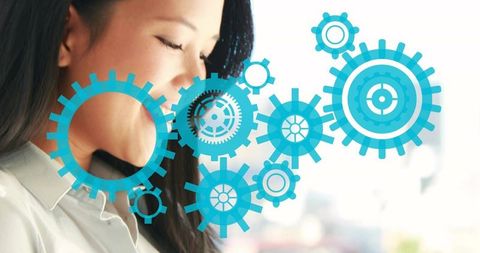 Asian businesswoman using smartphone with blue gear overlay representing automation