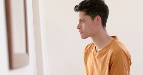 Thoughtful Man Using Tablet At Home For Inspiration