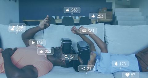 Father and Son Engaging in Virtual Reality with Social Media Icons