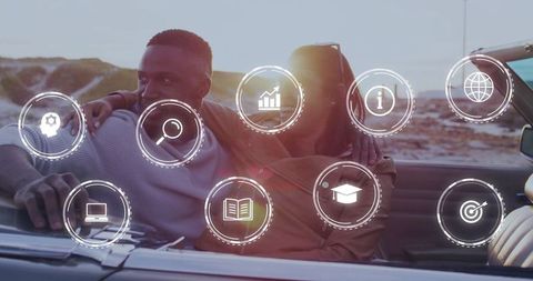 Couple driving convertible at ocean sunset with digital icons overlay for travel lifestyle
