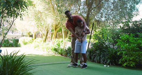 Father and Son Enjoying Backyard Golf Together