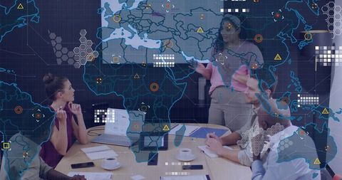 Team collaborating over global data dashboard with presenter pointing at interactive map