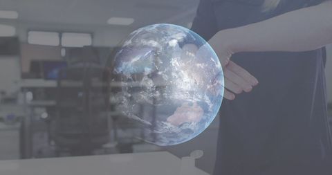 Woman Disinfecting Hands with Holographic Globe in Office - Download Free Stock Images Pikwizard.com