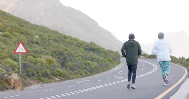 Senior Couple Jogging on Scenic Mountain Road - Download Free Stock Images Pikwizard.com